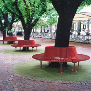 A row of circular red tree seats installed around trees in a public area in Melbourne.