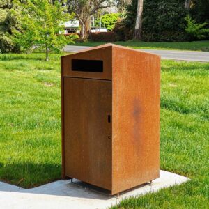 Weathering Steel Public Bin in a Grassy Park
