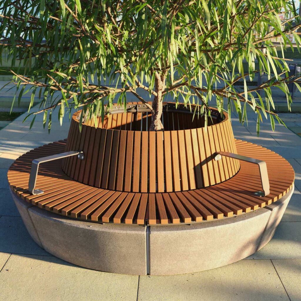 A circular tree seat encircles a small tree, with metal armrests.