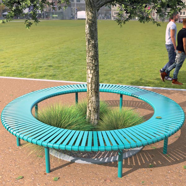 A circular teal bench surrounds a tree on a pathway with lush grass.