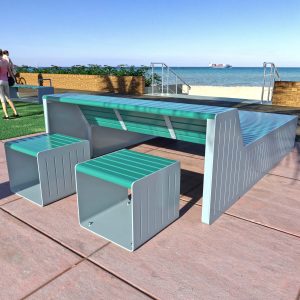 Beachside multi-use platform bench with integrated tables and stools