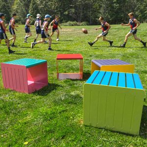 Commercial grade freestanding stools in front of a football field