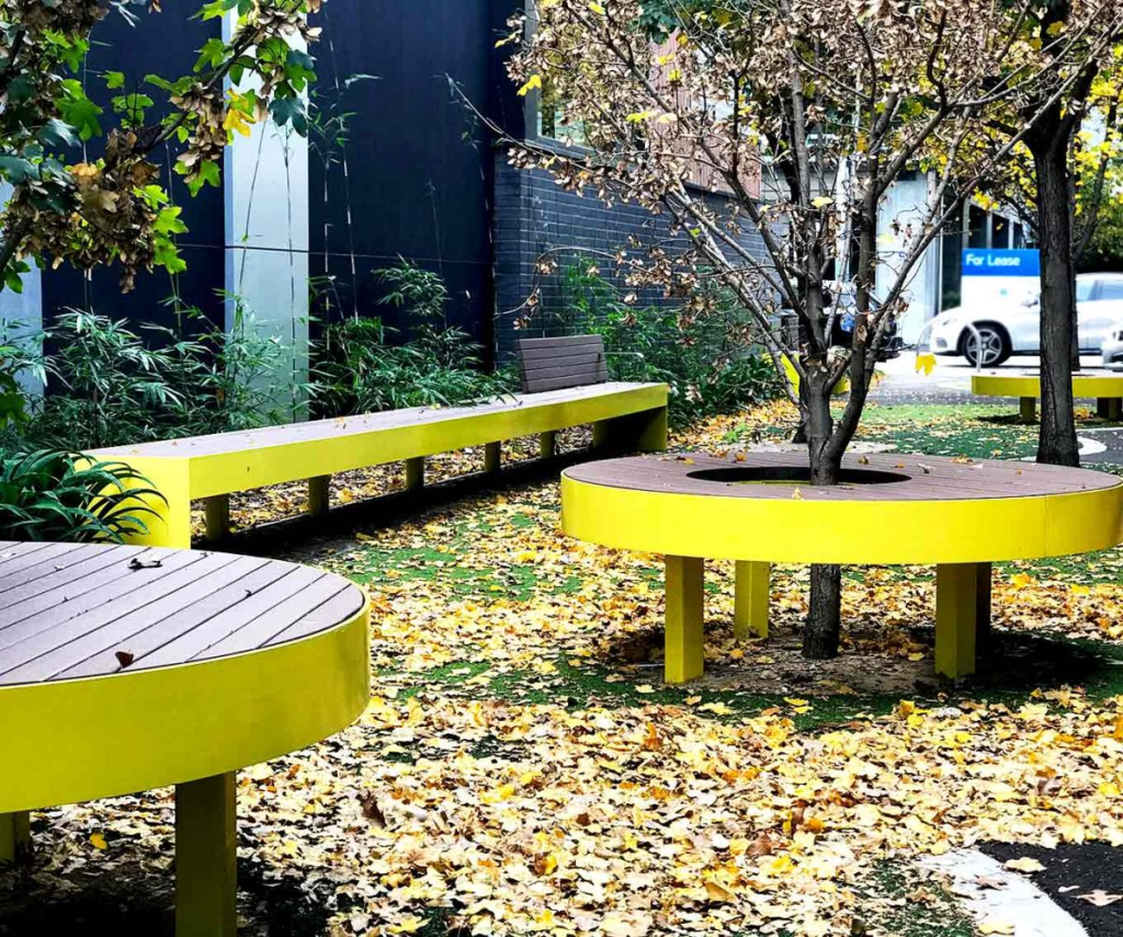 Yellow tree seating and park benches installed in the Hartwell shopping area in Camberwell, Victoria.