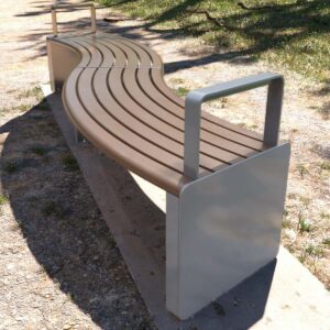 Curved benches forming an "S" shape placed along a park pathway