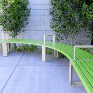 Curved and Straight Benches with armrests lined up together in a school garden space
