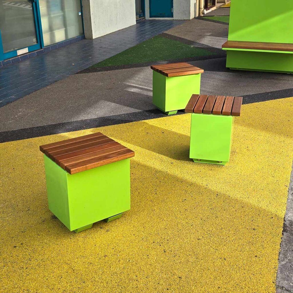 Matching Green Single Seat Benches and Planters in an alleyway