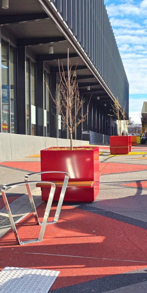 Colourful Planters placed along an alleyway in front of a shopping centre